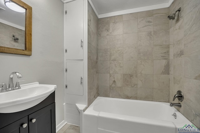 bathroom featuring vanity and tiled shower / bath