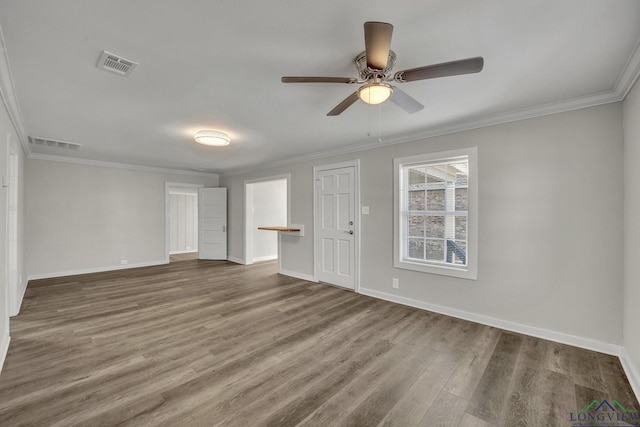 spare room featuring ceiling fan, crown molding, and dark wood-type flooring