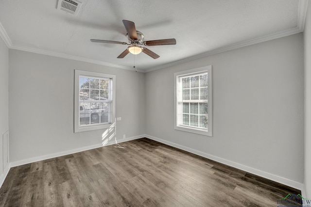 empty room with ceiling fan, wood-type flooring, a textured ceiling, and ornamental molding