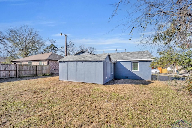 rear view of house with a lawn