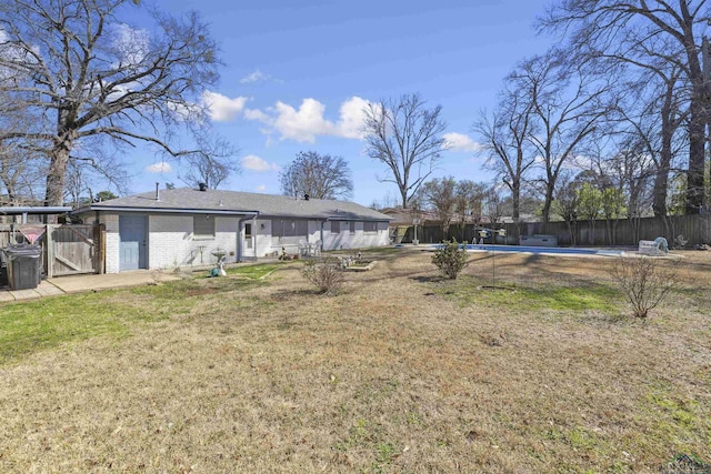 view of yard with a fenced in pool and fence