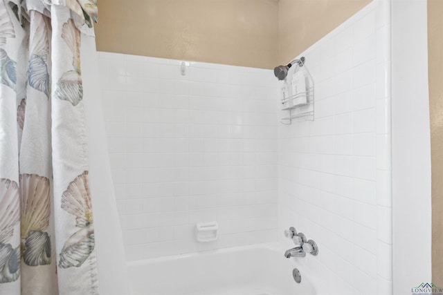 bathroom with shower / tub combo with curtain