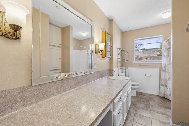 full bathroom with tile patterned floors, curtained shower, toilet, and vanity