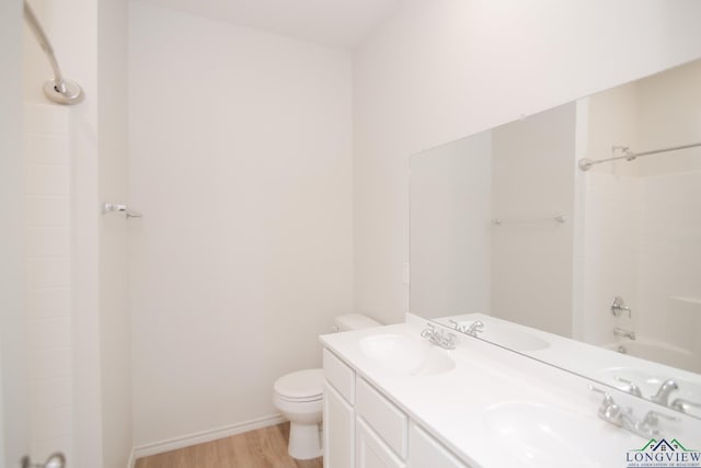 1146 Mission Creek Dr, Longview, TX 75601 - bathroom featuring wood finished floors, double vanity, and shower / bathtub combination