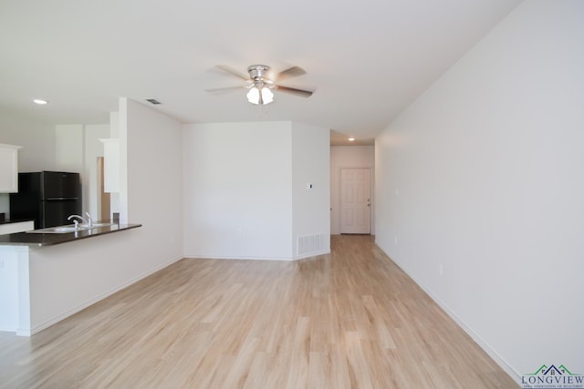1146 Mission Creek Dr, Longview, TX 75601 - unfurnished living room with light wood-style flooring, ceiling fan, and recessed lighting