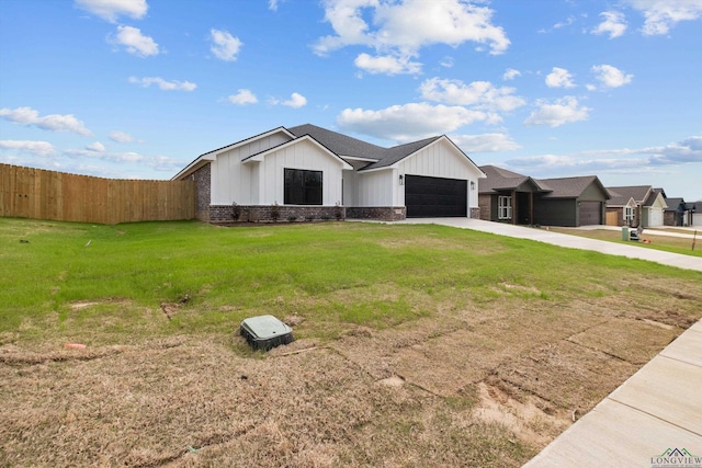 view of front of property with a garage, driveway, fence, a front lawn, and brick siding