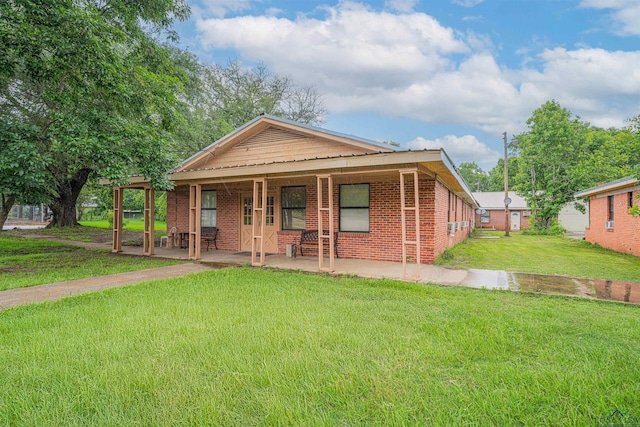911 S Helen St, Overton, TX 75684 - view of front of house featuring a front lawn and brick siding