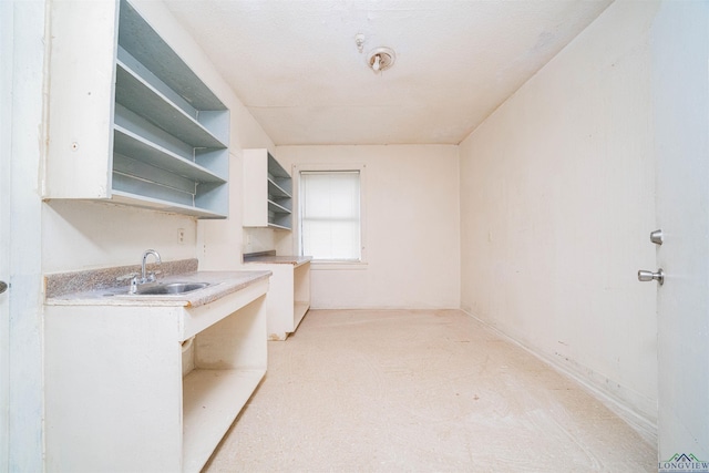 911 S Helen St, Overton, TX 75684 - kitchen featuring light carpet, open shelves, light countertops, and white cabinets