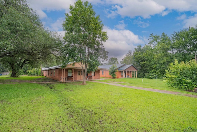 911 S Helen St, Overton, TX 75684 - view of green lawn with covered porch
