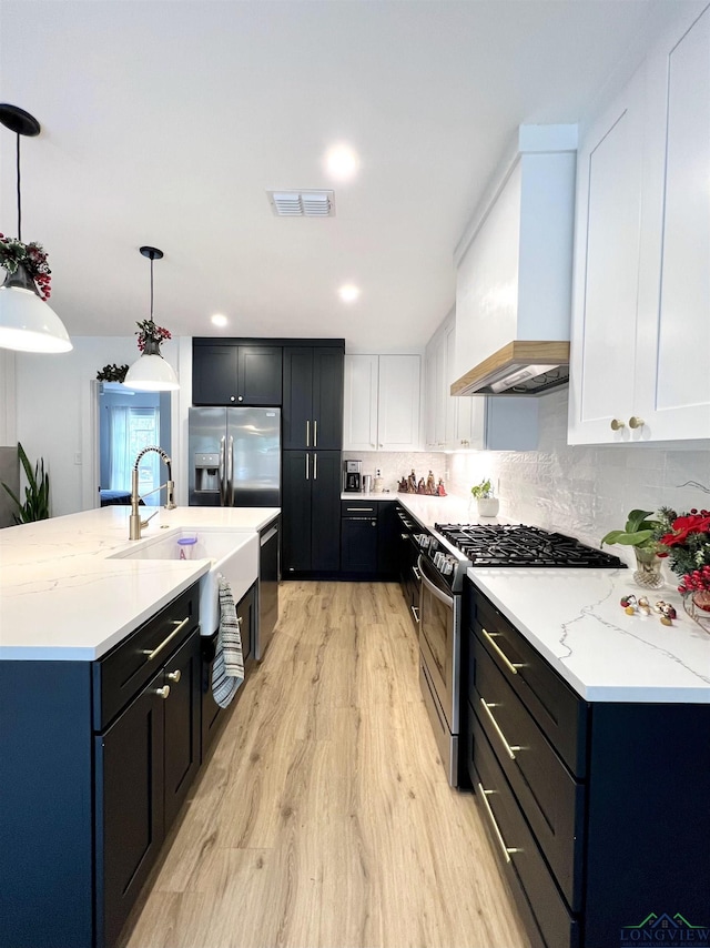 7 Rockwall Dr, Longview, TX 75604 - kitchen with appliances with stainless steel finishes, custom range hood, light wood finished floors, white cabinets, and recessed lighting