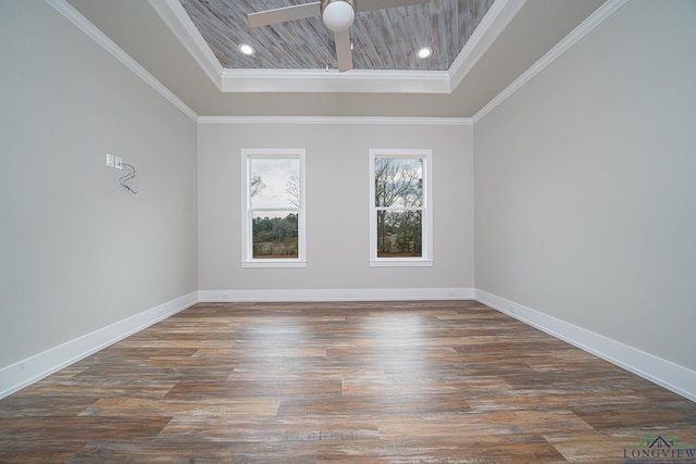 unfurnished room with a tray ceiling, ornamental molding, and dark hardwood / wood-style floors