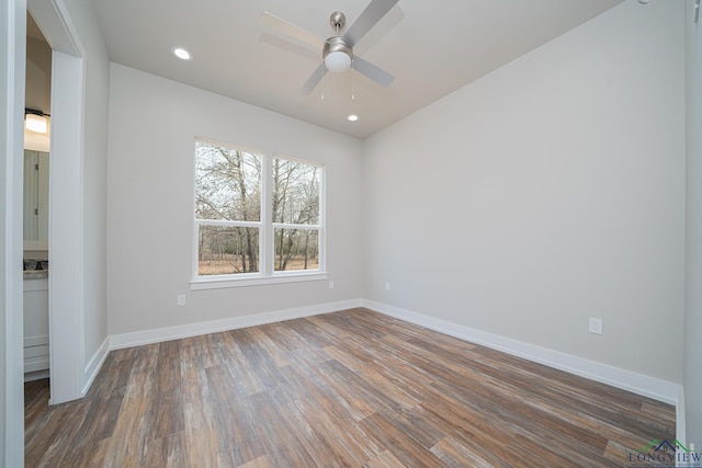 unfurnished room featuring dark wood-type flooring and ceiling fan