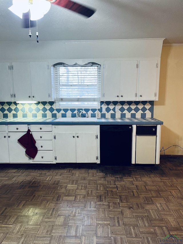 kitchen featuring white cabinets, backsplash, a textured ceiling, and dishwasher