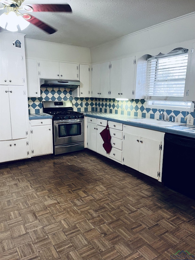 kitchen with stainless steel gas range oven, a textured ceiling, black dishwasher, decorative backsplash, and white cabinets