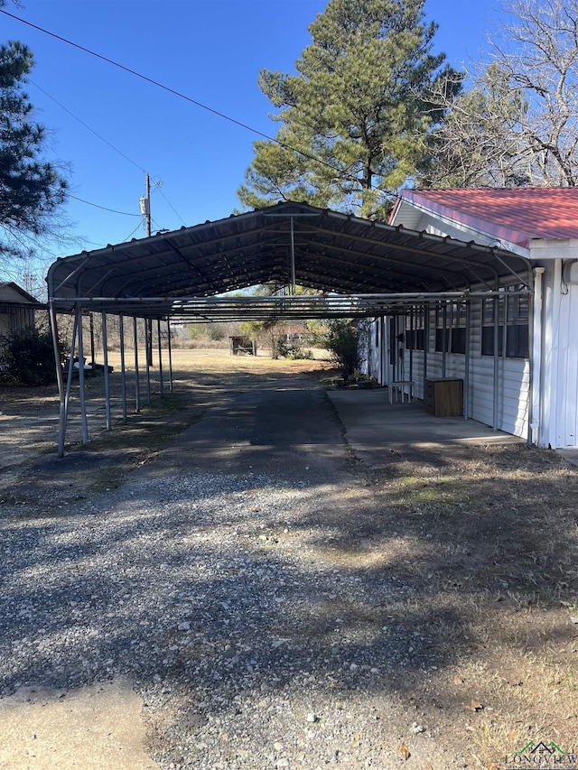 view of parking / parking lot featuring a carport