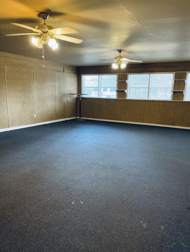 unfurnished room with ceiling fan and carpet