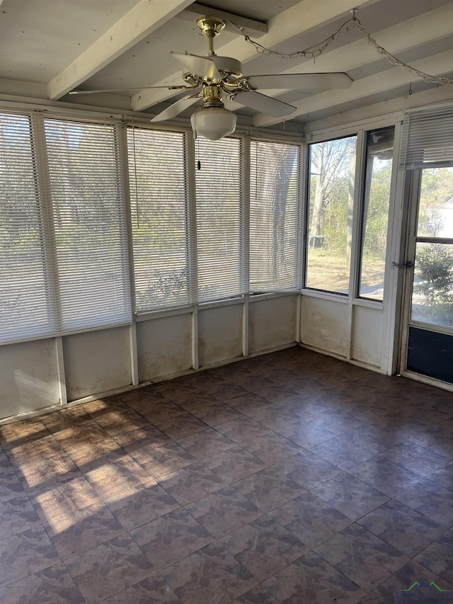 unfurnished sunroom featuring ceiling fan