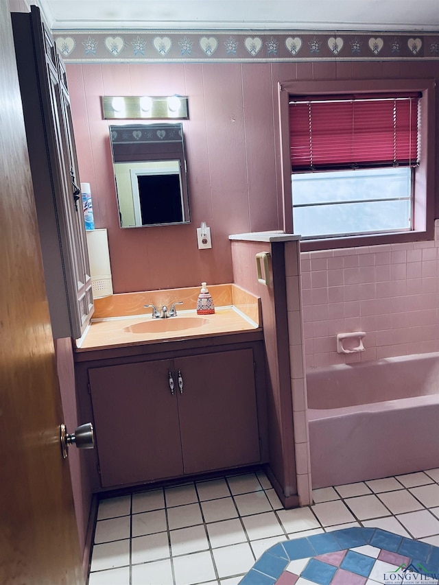 bathroom featuring tile patterned flooring, vanity, and tiled shower / bath