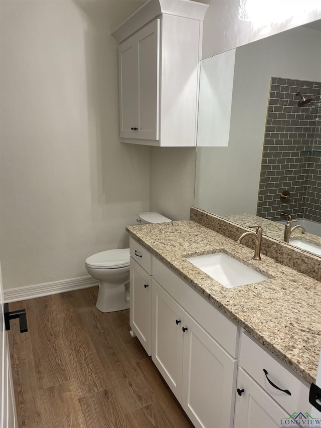 bathroom featuring hardwood / wood-style floors, vanity, and toilet