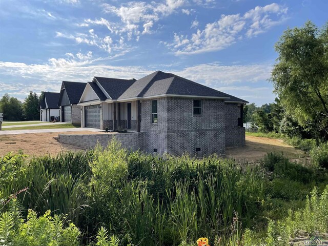 view of side of home featuring a garage