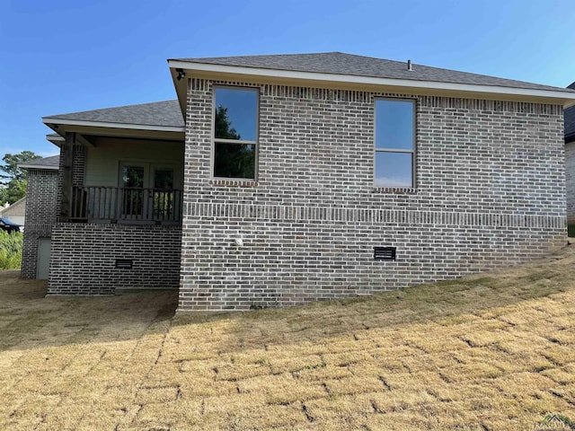 view of side of home featuring a lawn