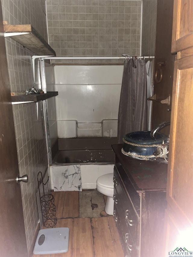 1401 Gay St, Longview, TX 75602 - full bathroom with toilet, shower / bath combo with shower curtain, vanity, and wood finished floors