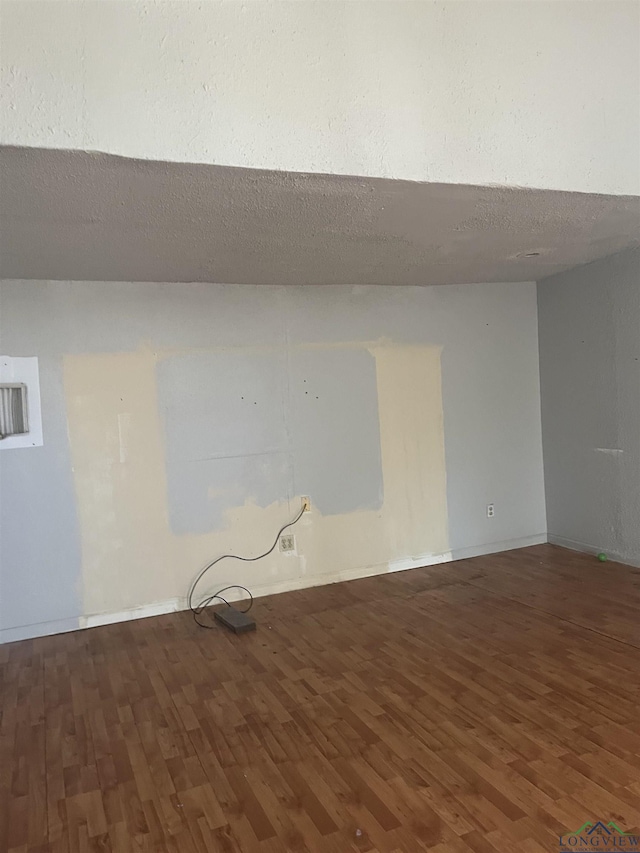 1401 Gay St, Longview, TX 75602 - unfurnished room with baseboards and wood finished floors