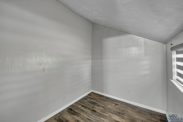 585 Naples Dr, Omaha, TX 75571 - unfurnished room featuring baseboards, dark wood-style flooring, and lofted ceiling