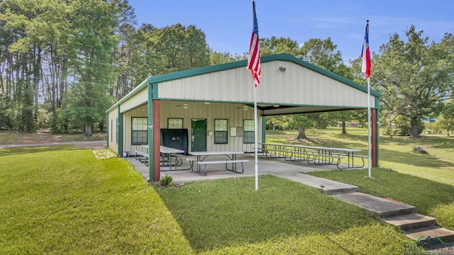 585 Naples Dr, Omaha, TX 75571 - exterior space with board and batten siding, ceiling fan, a patio area, and a front yard