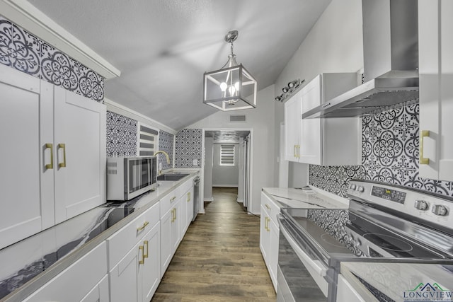 585 Naples Dr, Omaha, TX 75571 - kitchen featuring wall chimney range hood, a sink, appliances with stainless steel finishes, backsplash, and vaulted ceiling