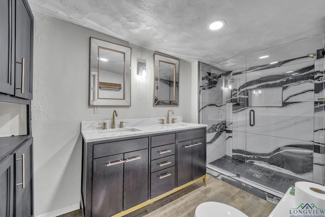 585 Naples Dr, Omaha, TX 75571 - full bath with double vanity, a marble finish shower, a sink, and wood finished floors