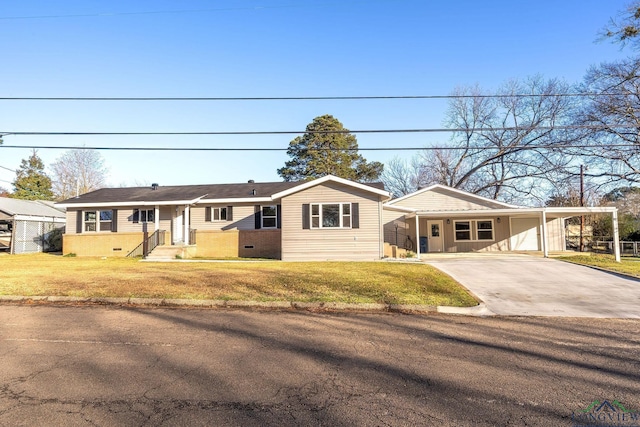 2210 E Harold St, Gladewater, TX 75647 - ranch-style house with a carport, driveway, and a front lawn
