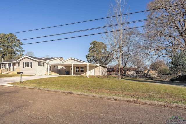2210 E Harold St, Gladewater, TX 75647 - view of front of house with a front lawn, an attached carport, and driveway
