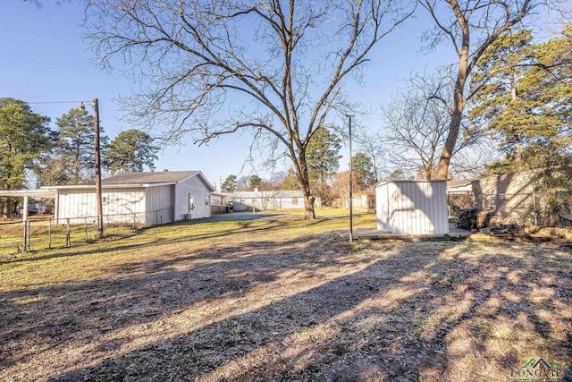 2210 E Harold St, Gladewater, TX 75647 - view of yard with a storage shed, fence, and an outbuilding