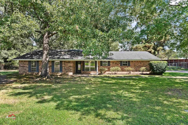 ranch-style home featuring a front yard