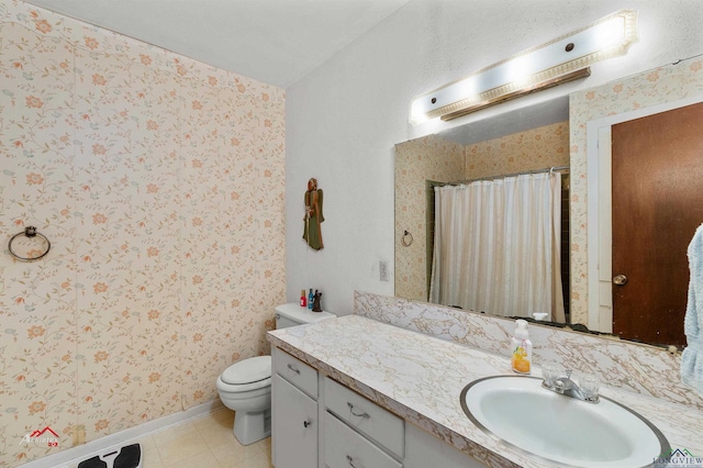 bathroom with vanity, toilet, and curtained shower