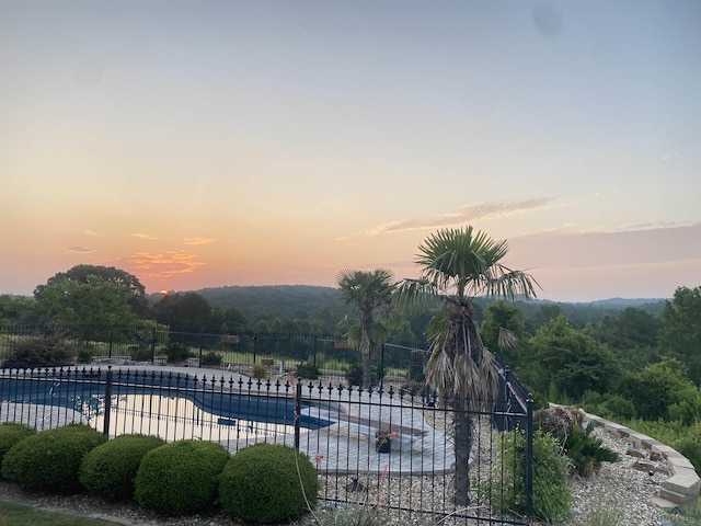 view of pool at dusk