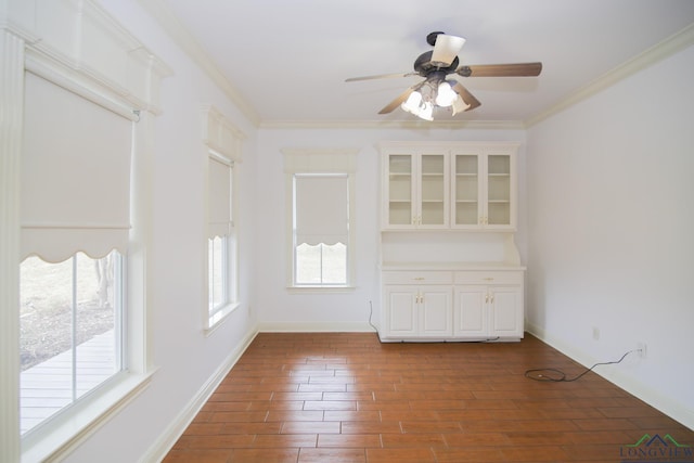 spare room featuring ceiling fan and ornamental molding