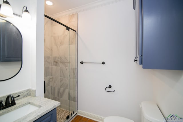 bathroom featuring vanity, toilet, ornamental molding, and walk in shower