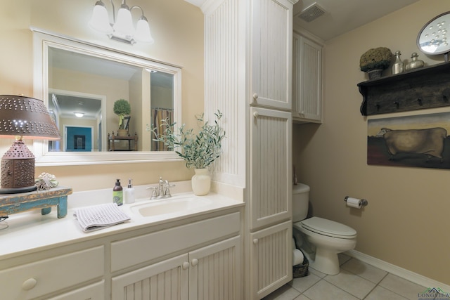 bathroom featuring toilet, vanity, and tile patterned floors