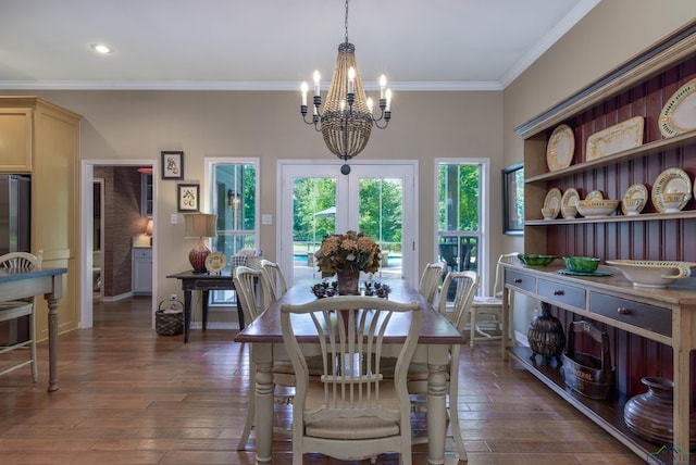 dining space with ornamental molding, dark hardwood / wood-style floors, and a notable chandelier