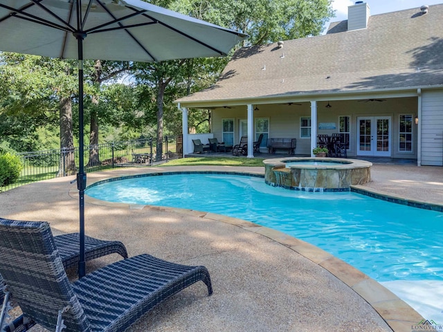 view of swimming pool with an in ground hot tub, french doors, pool water feature, ceiling fan, and a patio