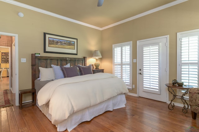 bedroom featuring ceiling fan, wood-type flooring, crown molding, and access to outside