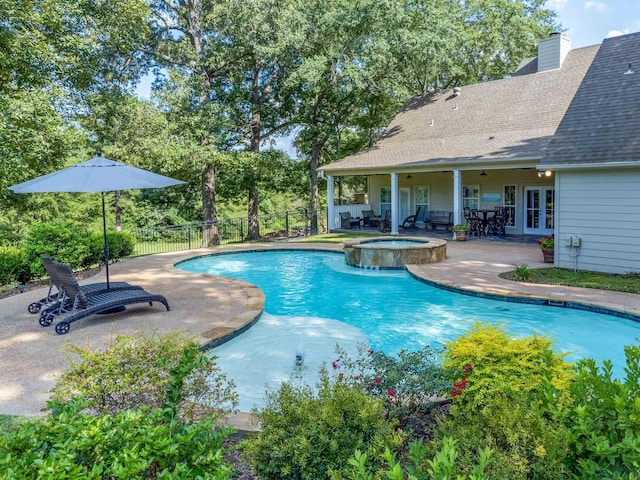 view of pool with a patio area, an in ground hot tub, and french doors