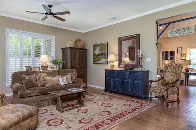 living room featuring ceiling fan, ornamental molding, and hardwood / wood-style flooring