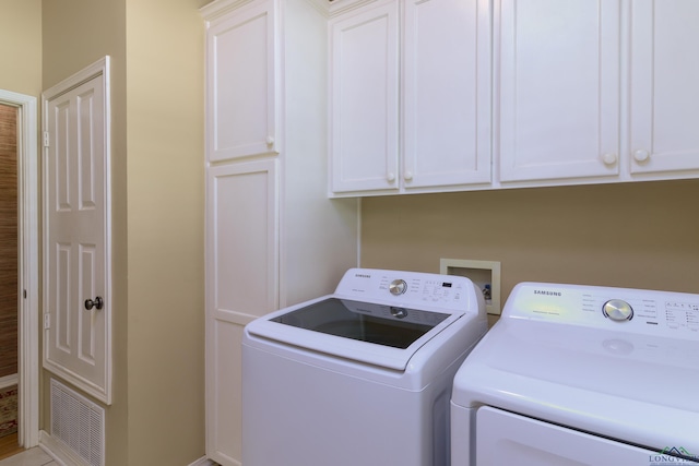 laundry area with cabinets and independent washer and dryer