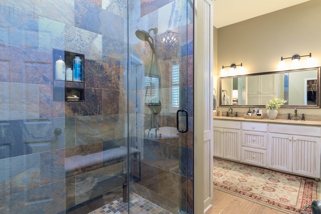 bathroom featuring hardwood / wood-style floors, vanity, and an enclosed shower