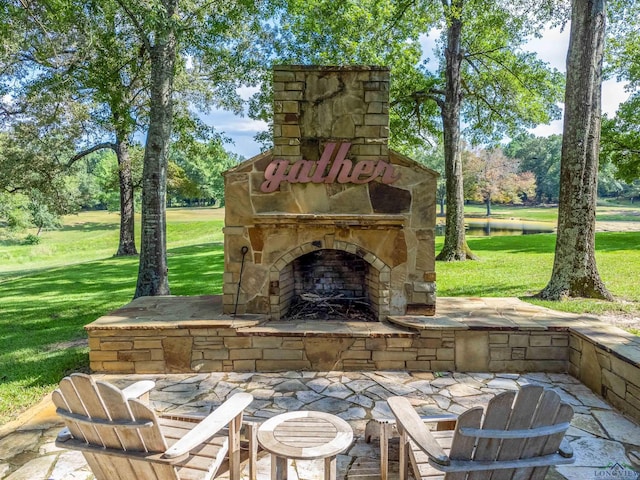 view of patio featuring an outdoor stone fireplace