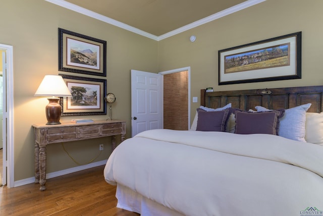 bedroom featuring hardwood / wood-style floors and ornamental molding