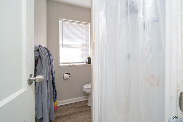 bathroom featuring hardwood / wood-style floors and toilet